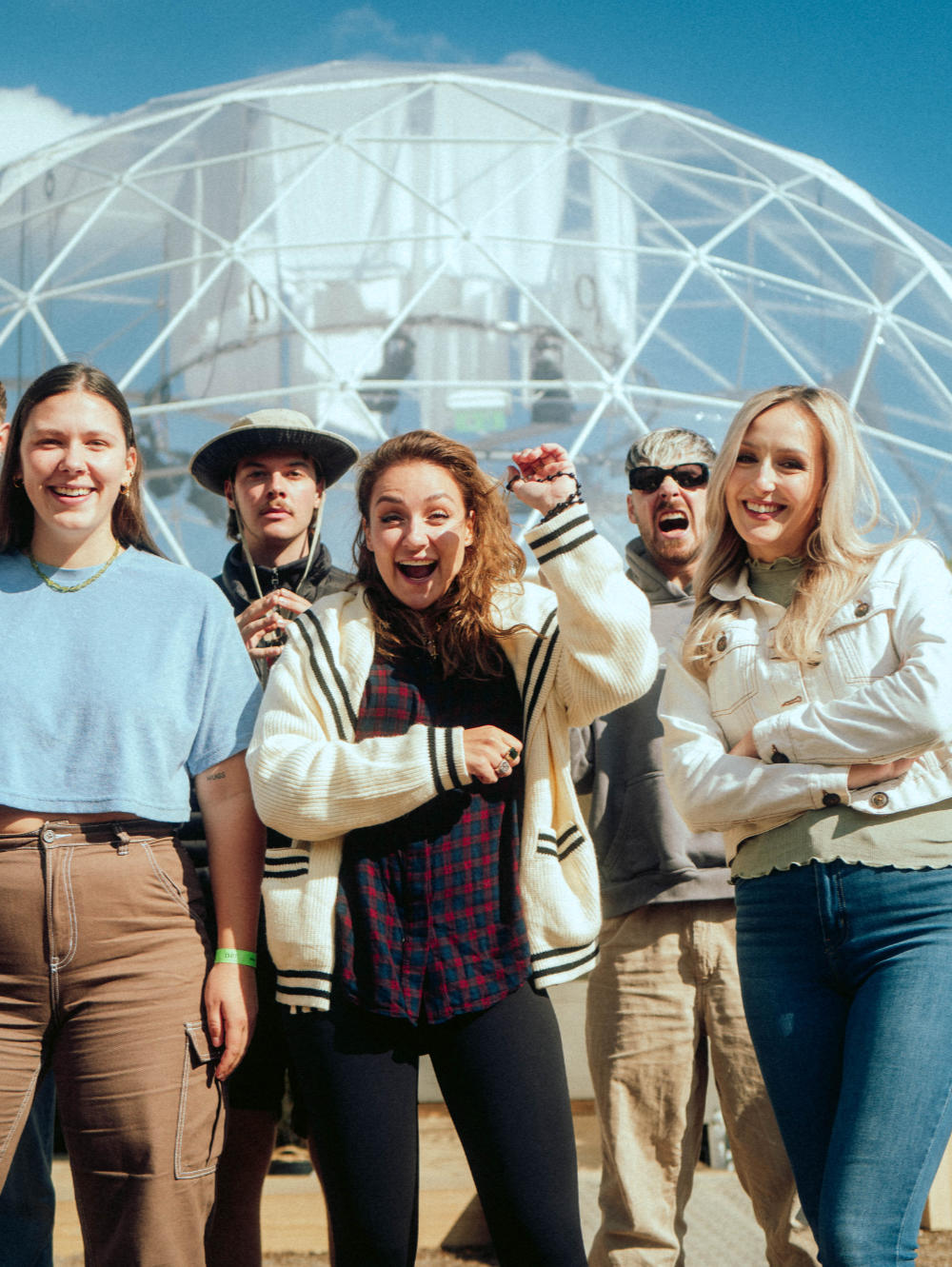 Group of people in front of a geodesic structure